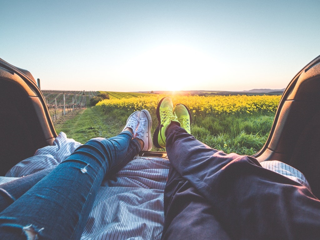 a couple laying on a picnic blanket on a date