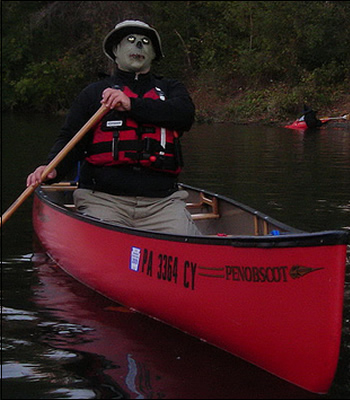 man dressed as a zombie in a canoe