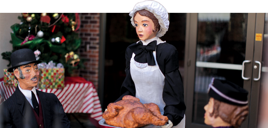 pilgrim mannequins holding a prop turkey