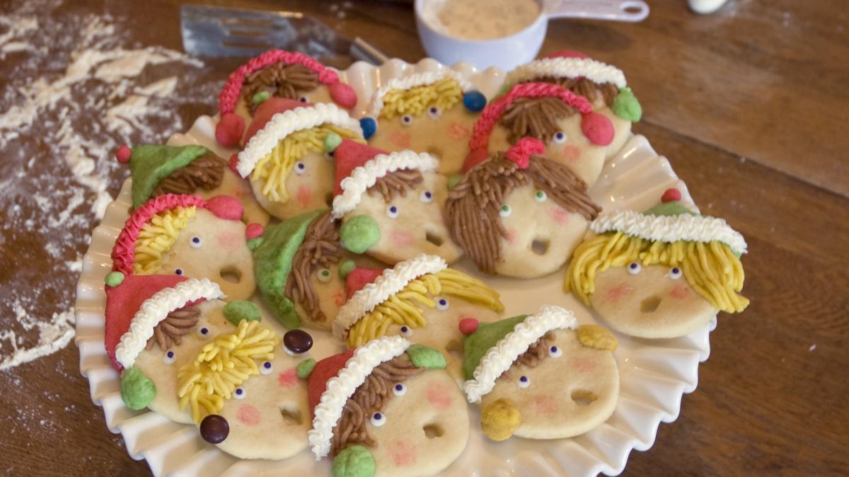 cookies decorated as faces with winter caps