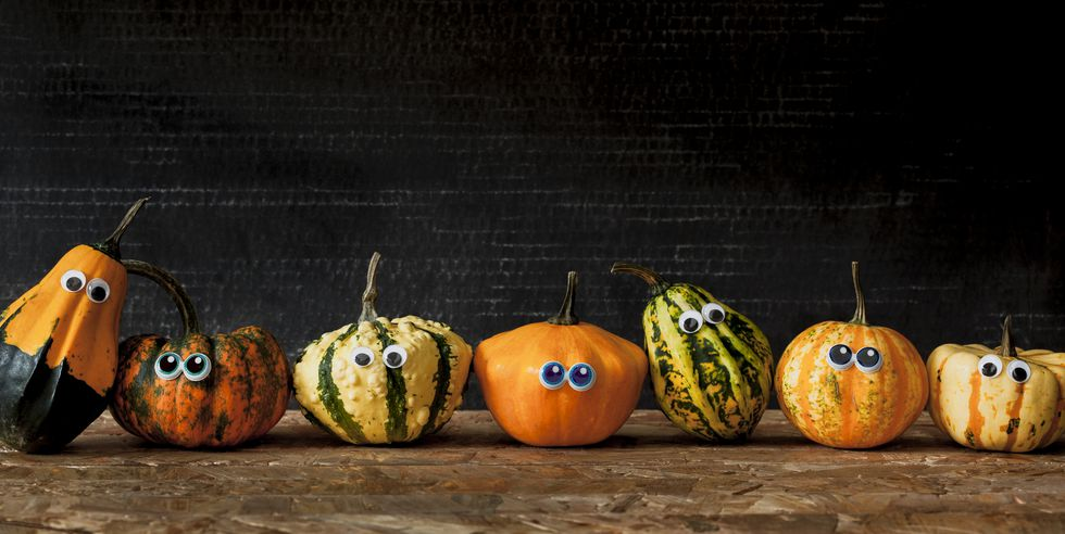 various different pumpkins with googly eyes