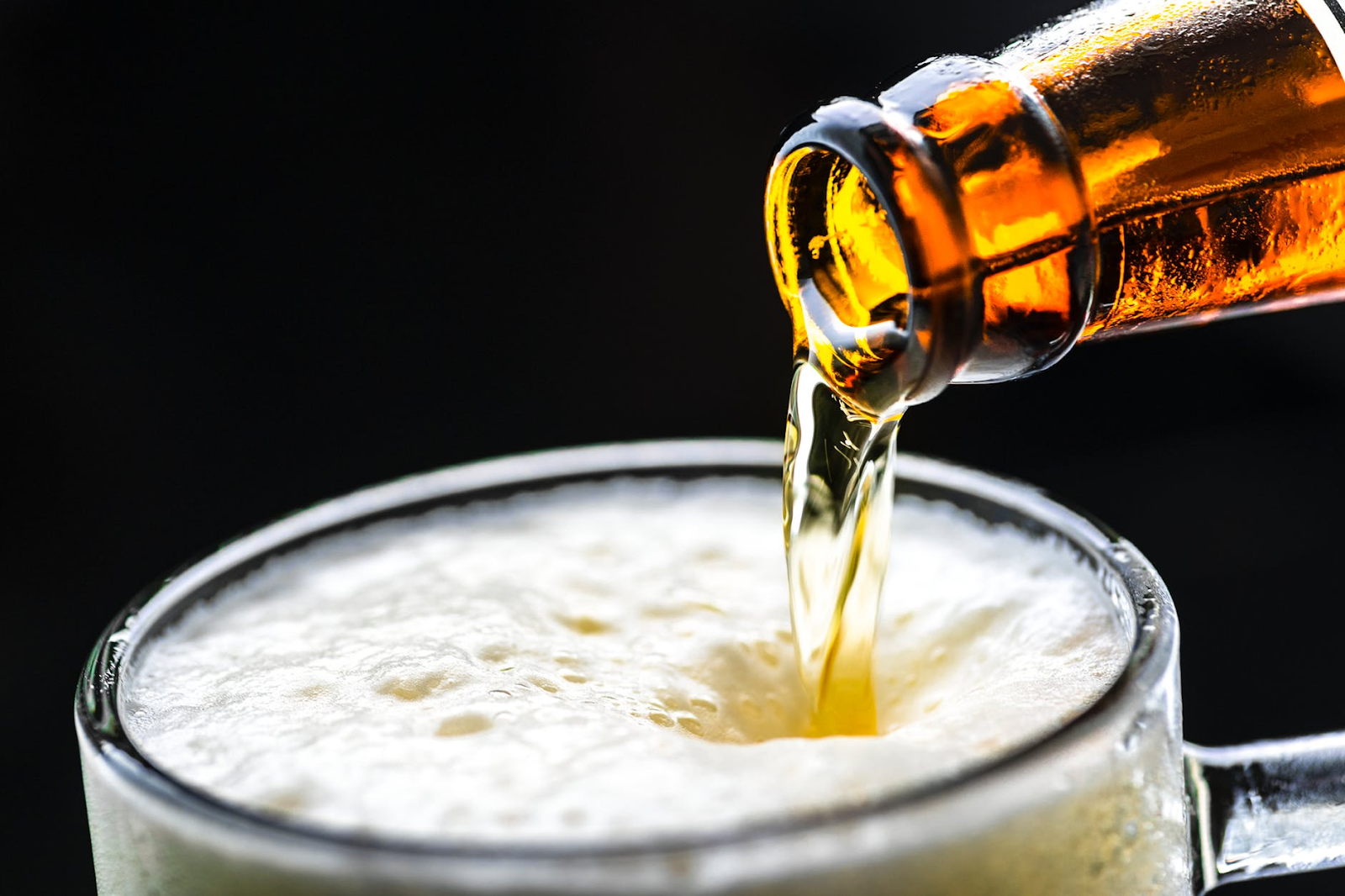 beer being poured into a pitcher