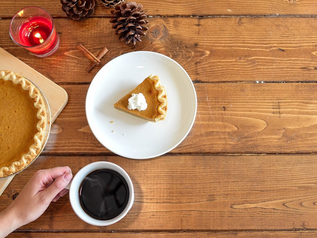 a table with pumpkin pie and coffee