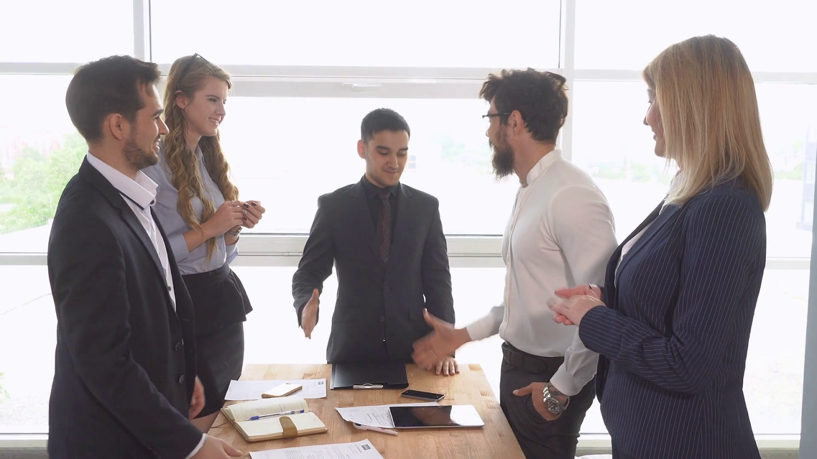 realtor shaking hands with clients