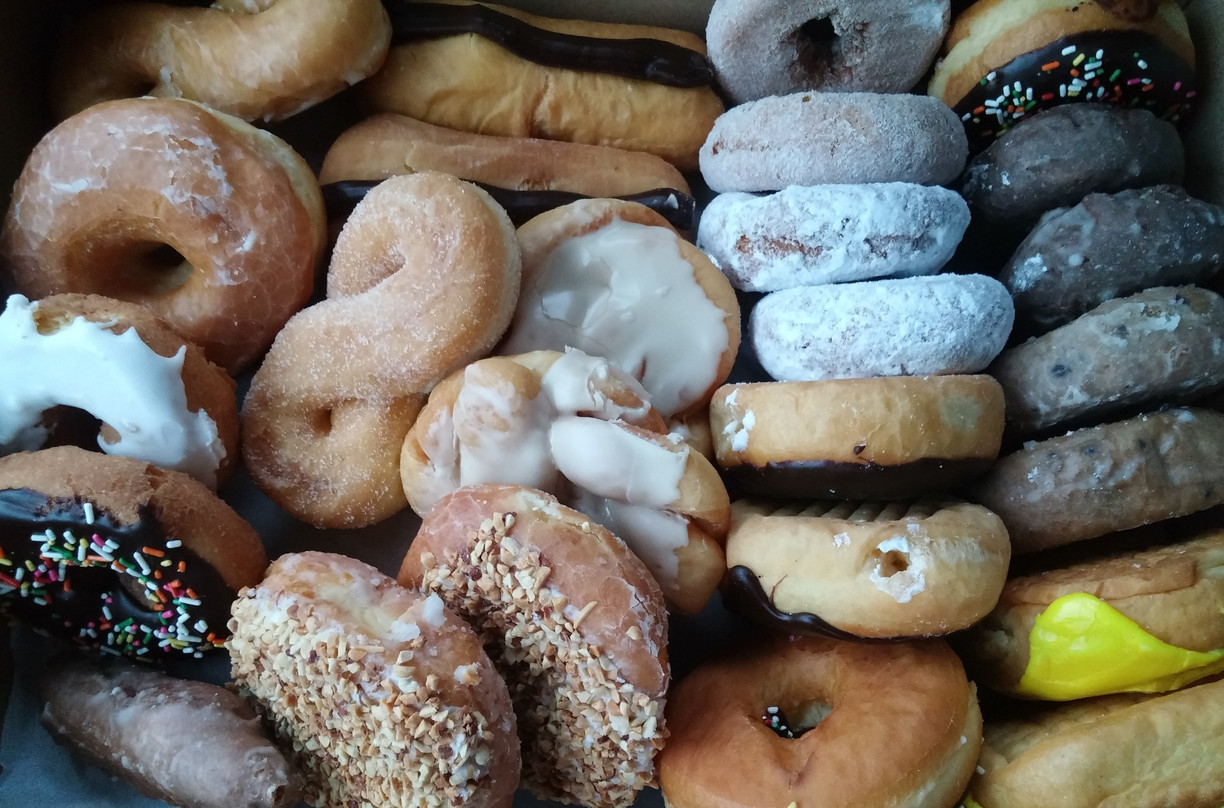 close up of various donuts and other pastries