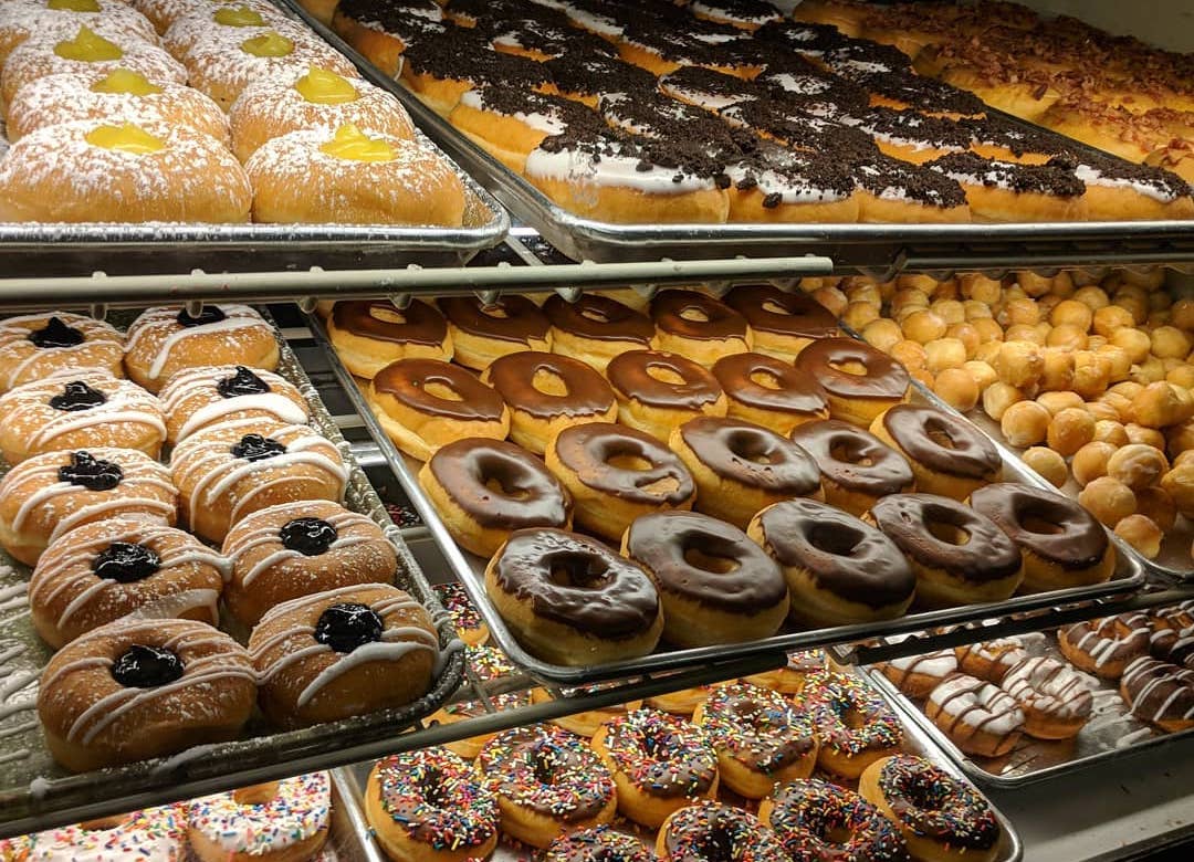 Donut varieties in case at Lil Donut Factory