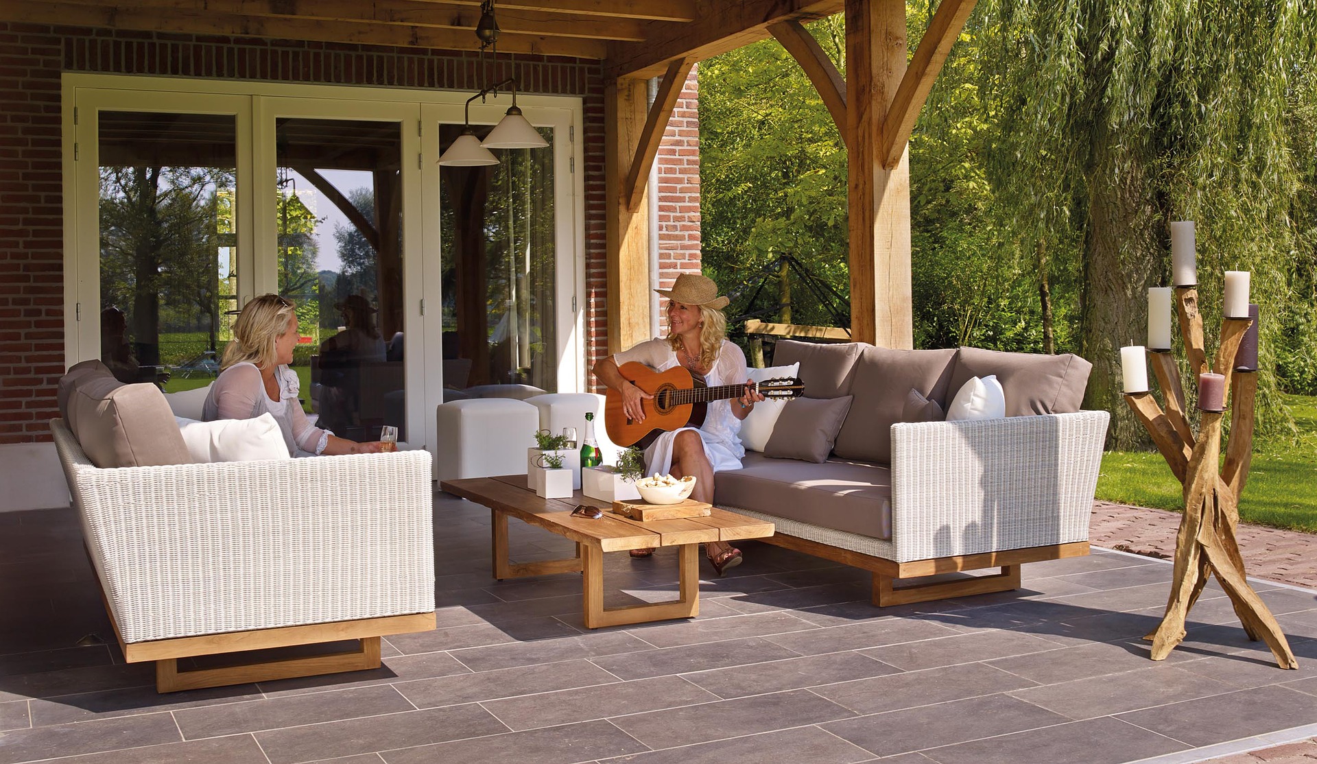 women sit in modern "living room" patio