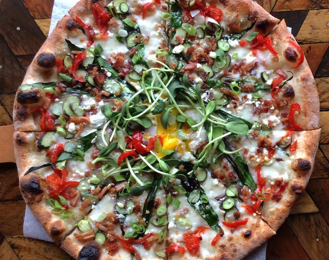 Veggie pizza with pea sprouts