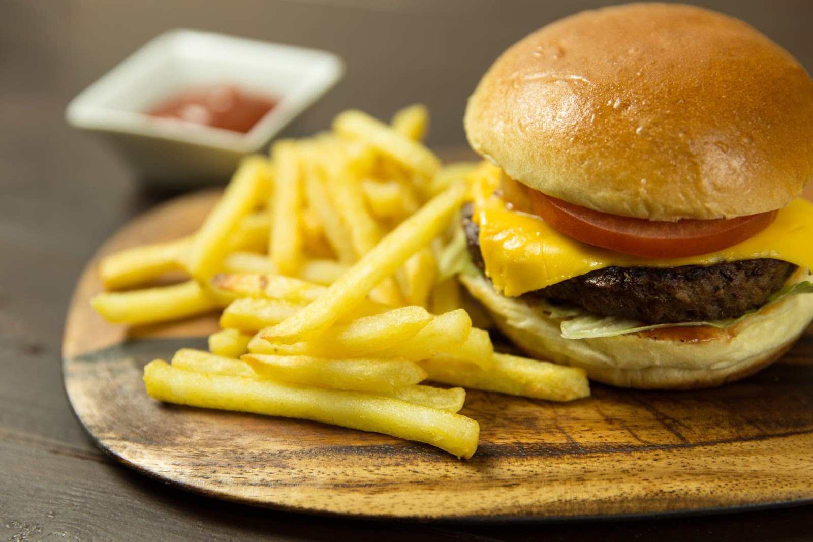 cheeseburger and fries on a wooden tray from Landing Tavern