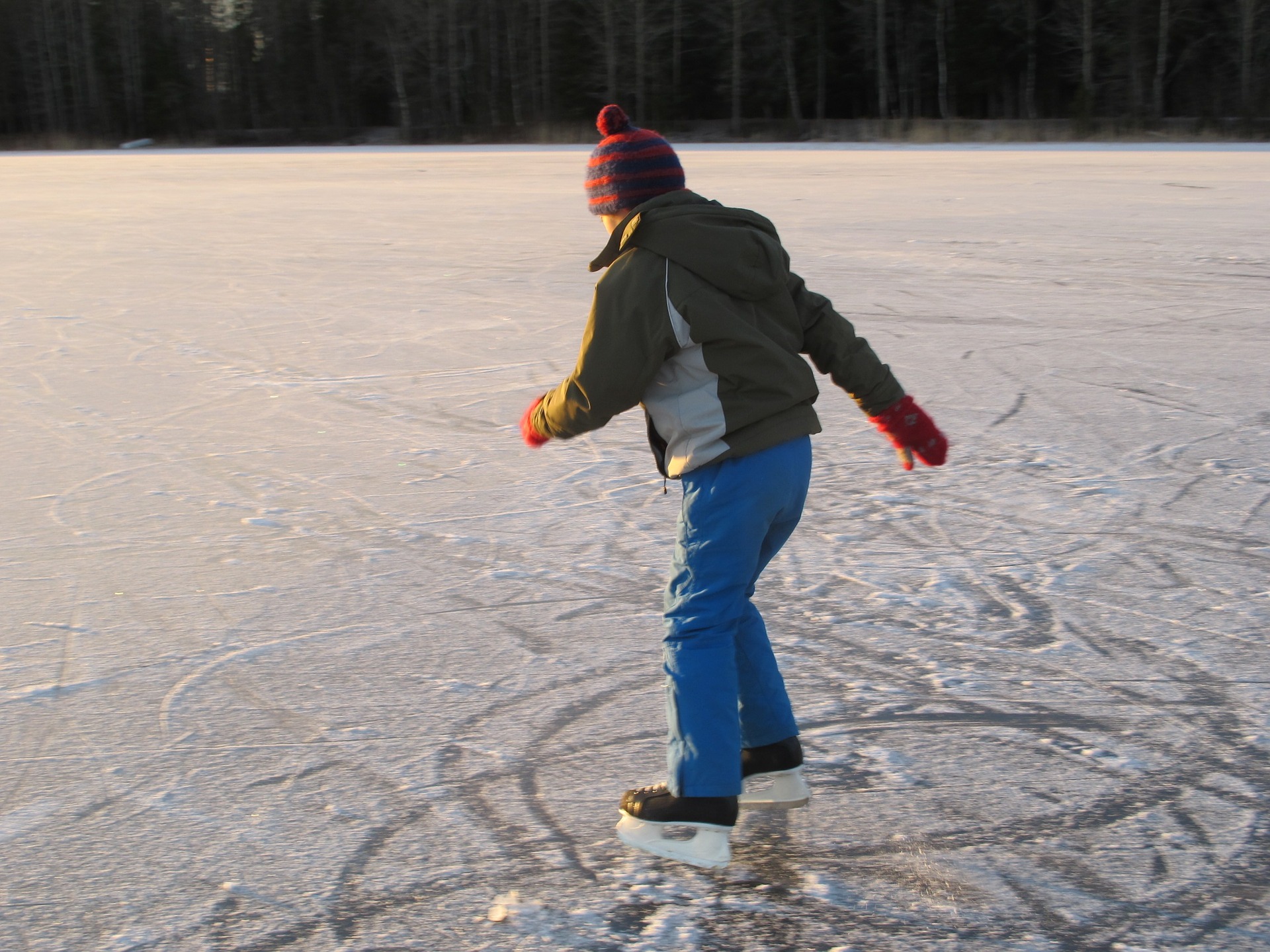 skater ice skating outside on frozen pond