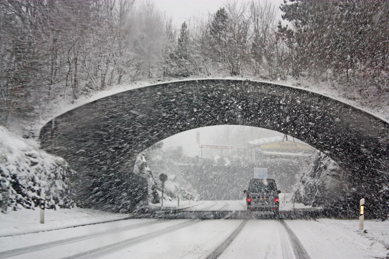 a car driving under a tunnel in a blizzard