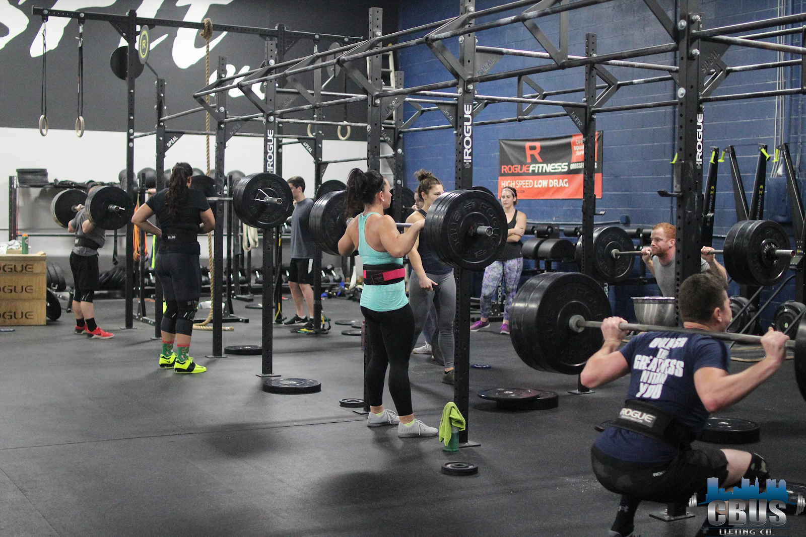 Group of athletes power squatting