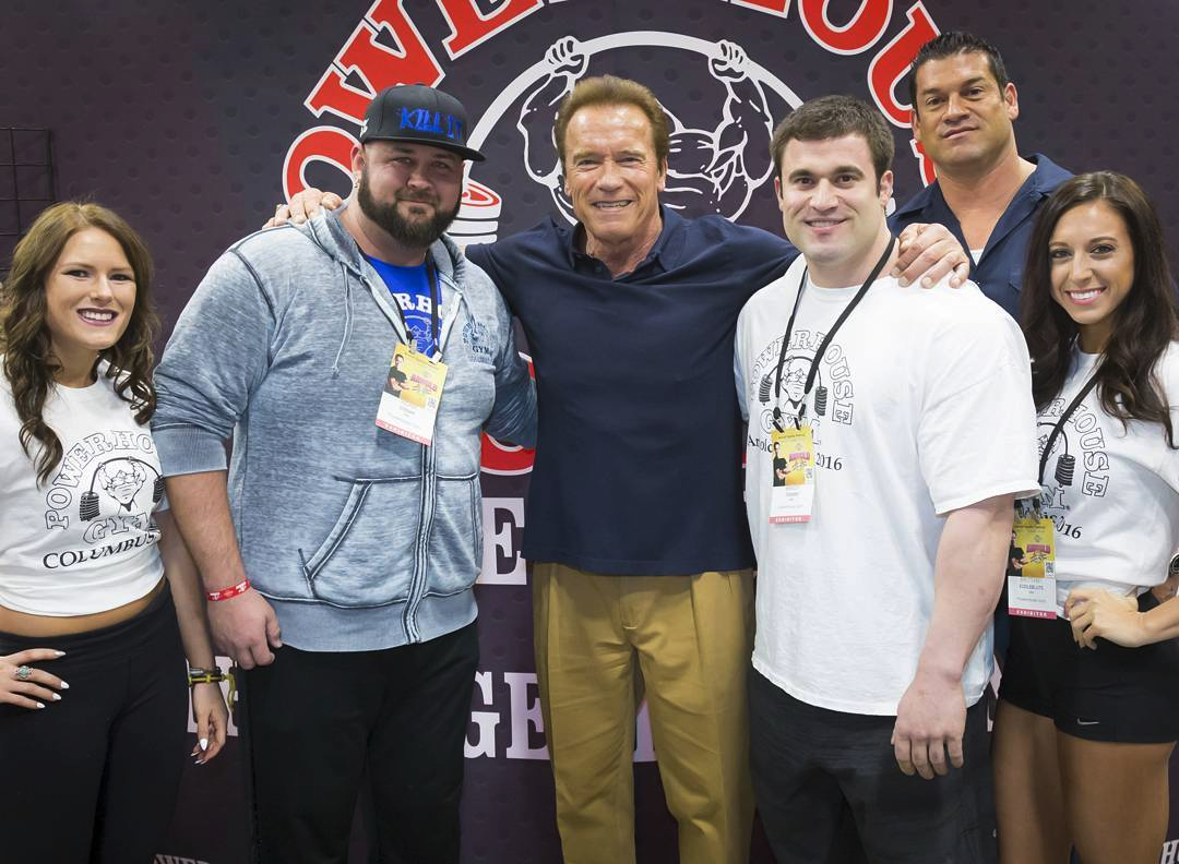 Powerhouse members posing with Arnold Schwarzenegger