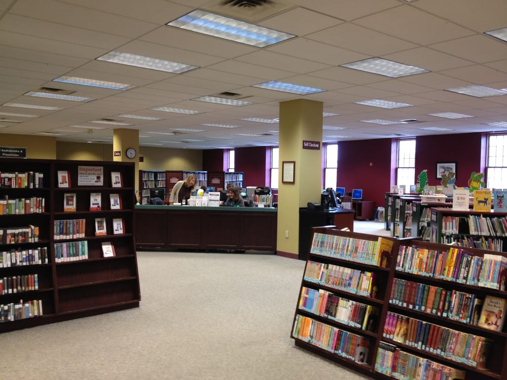 neat shelves are arranged through the red and gold main room of the lancaster, OH fairfield county library