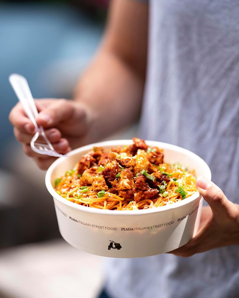 a person eats a bowl of pasta from upper arlington's piada restaurant