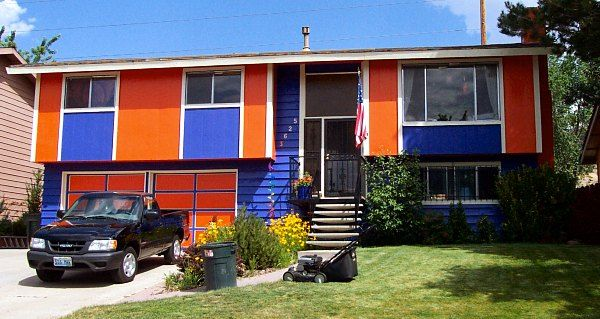 Blue and orange two-story home with truck in driveway