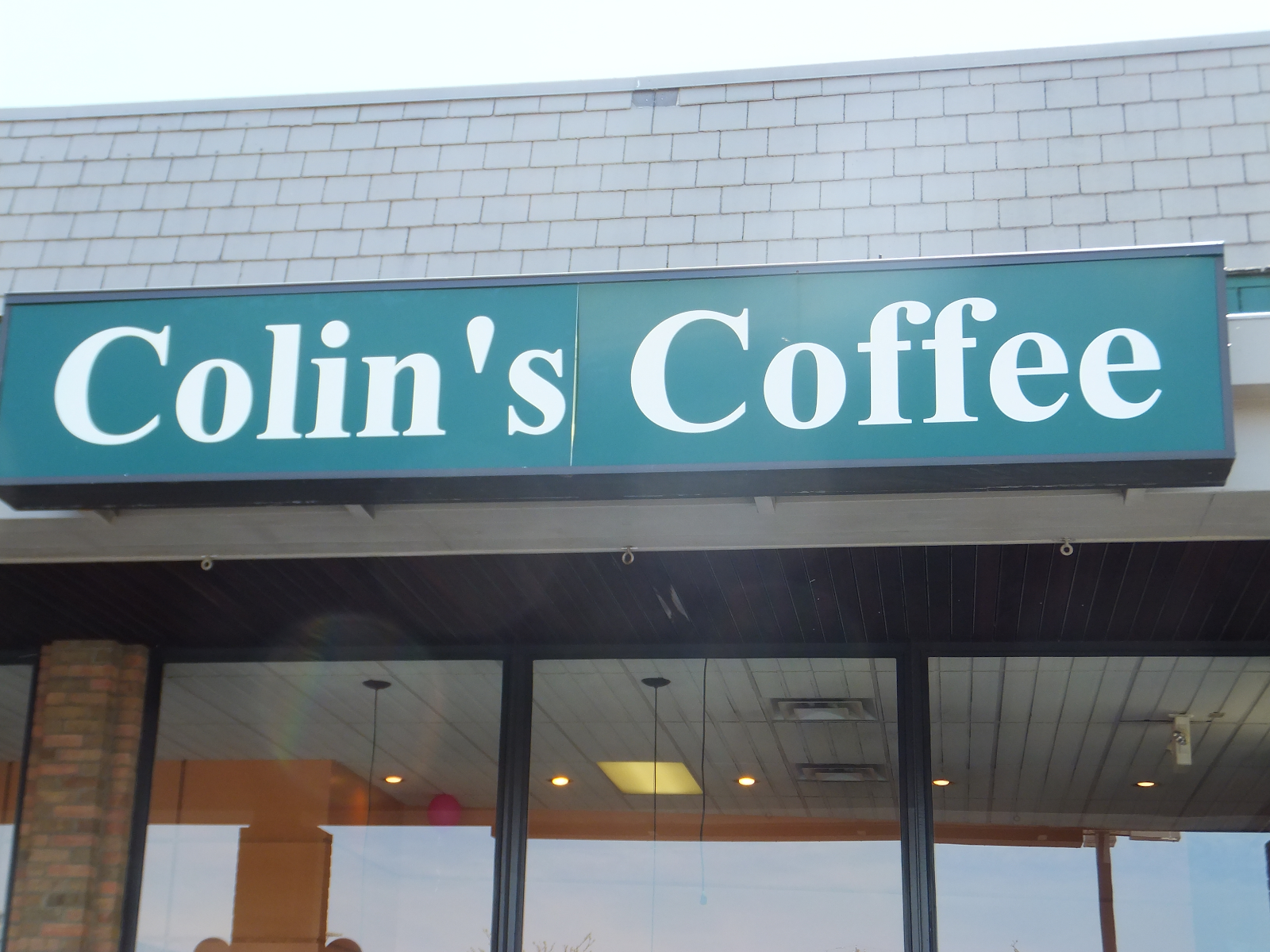 blue Colin's Coffee sign on building