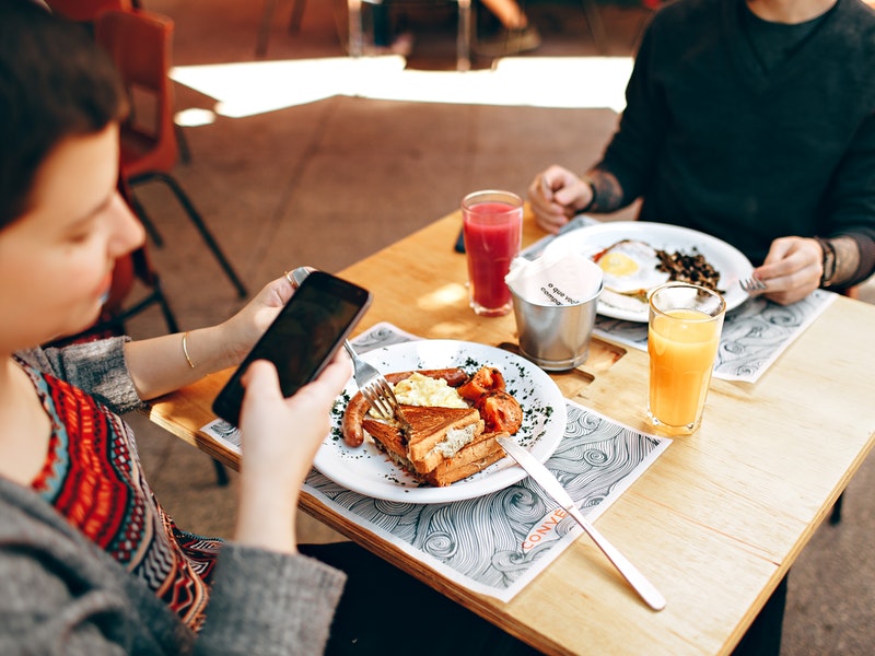 A couple at a table with breakfast and juice