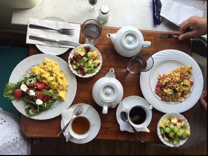 A table with breakfast dishes, fruit, and coffee from The Table Columbus