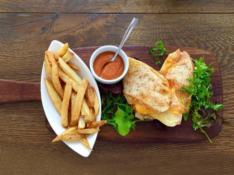 A close-up of fries and a sandwich