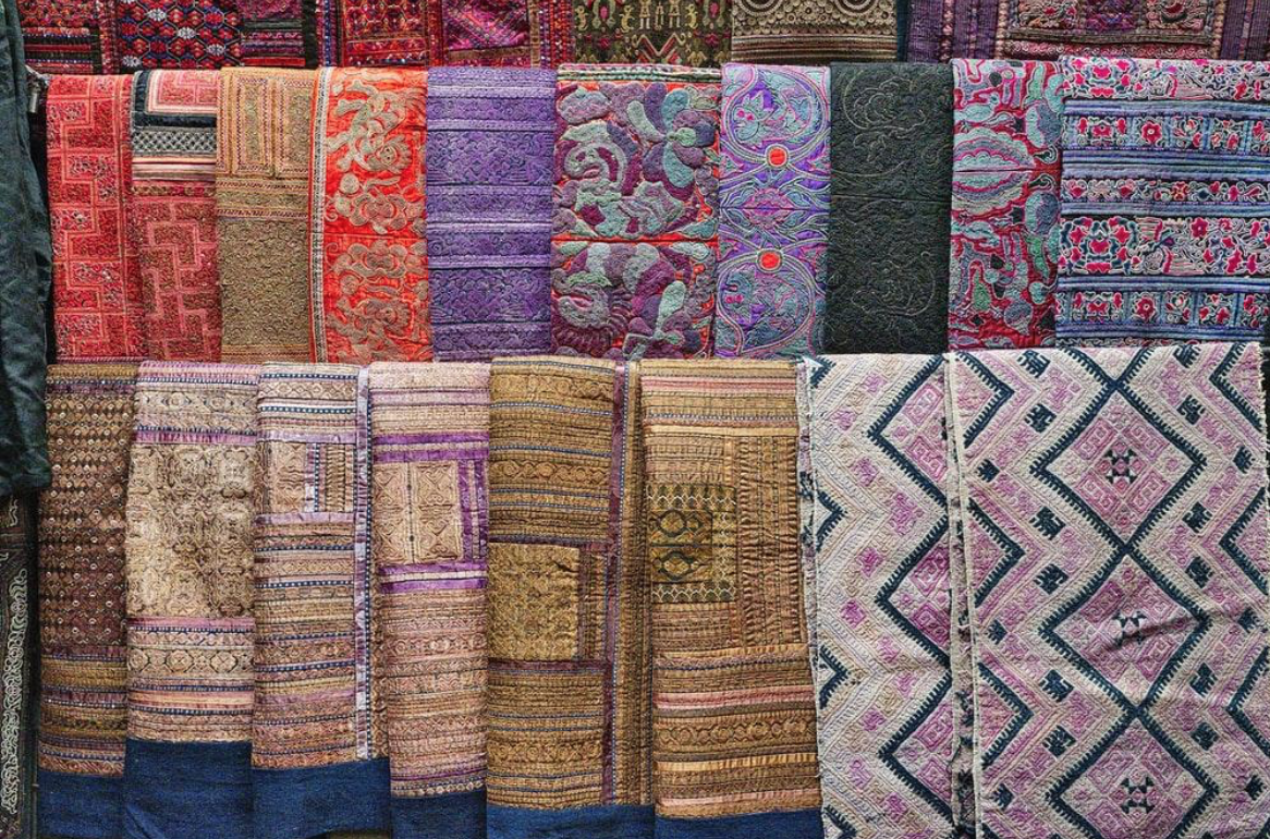 A display of rugs with a variety of colors and textures