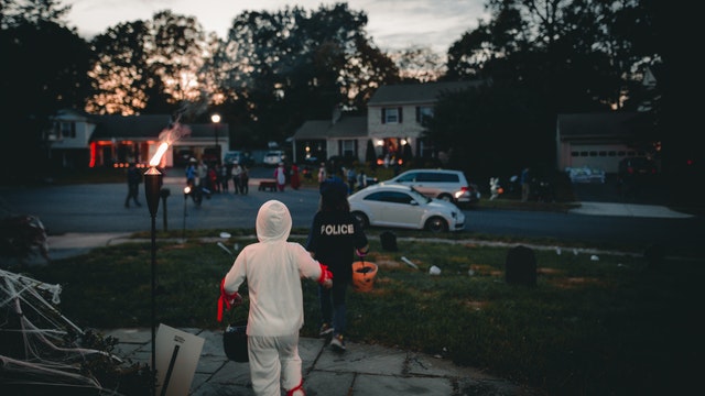 children trick or treat in a cul de sac on halloween night