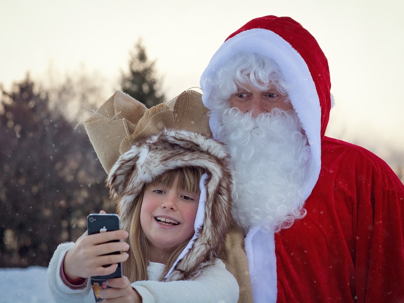 kid takes picture with santa