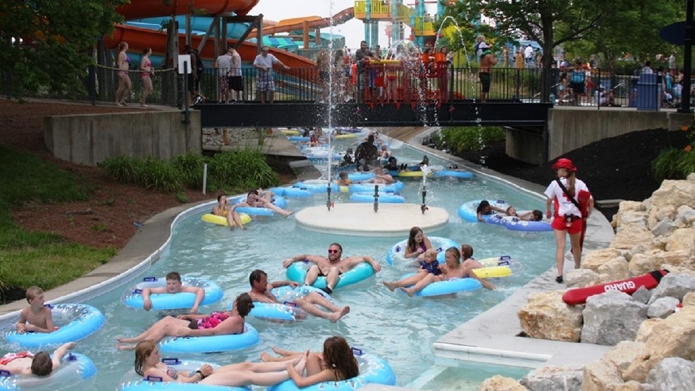 People relax on inner tubes as they float down a pool river at a waterpark