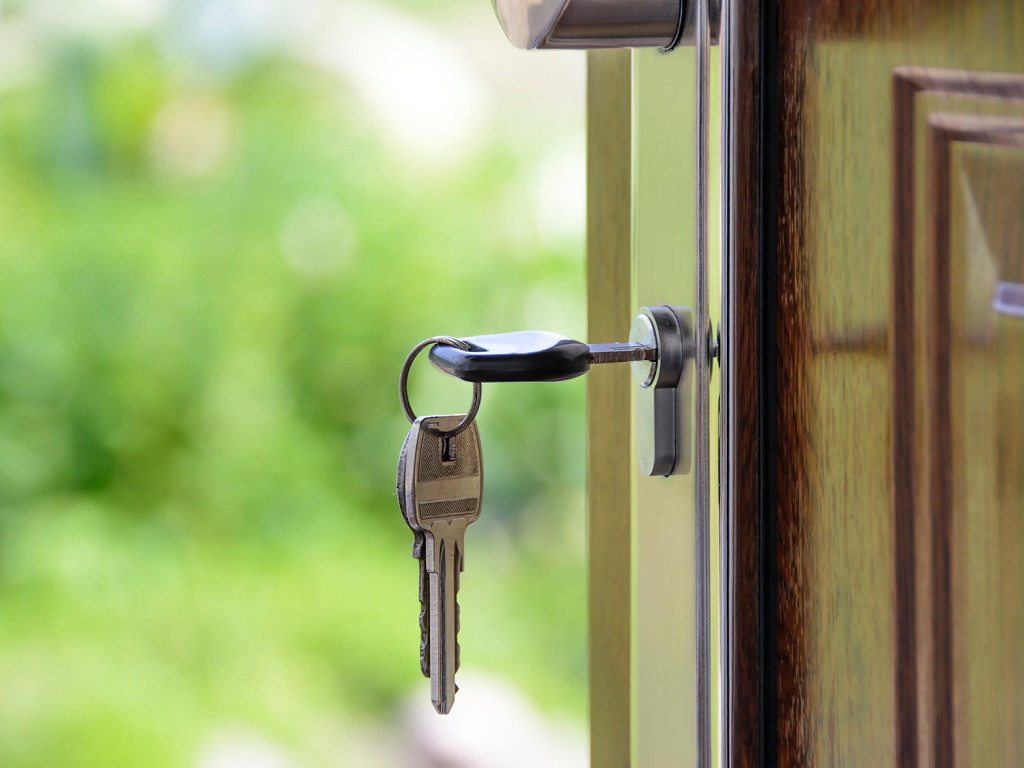 a key in the door of a home