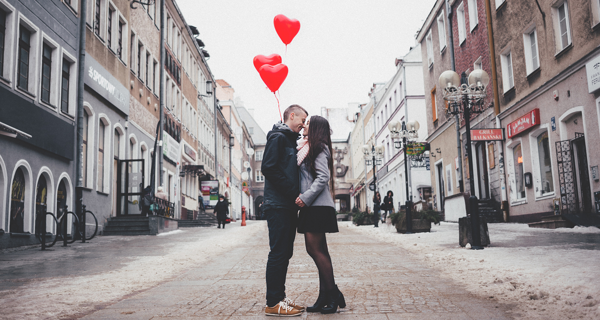 a couple kisses in the middle of the street