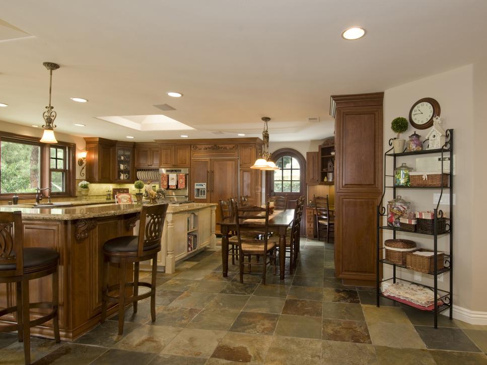 A kitchen made of hardwood and dark stone floors.