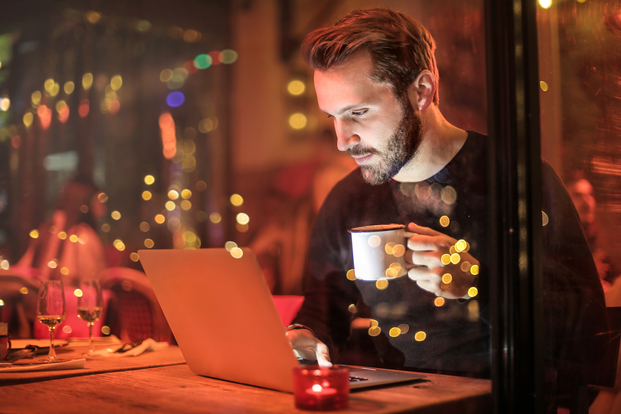 Man working in a restaurant with a cup of tea or coffee