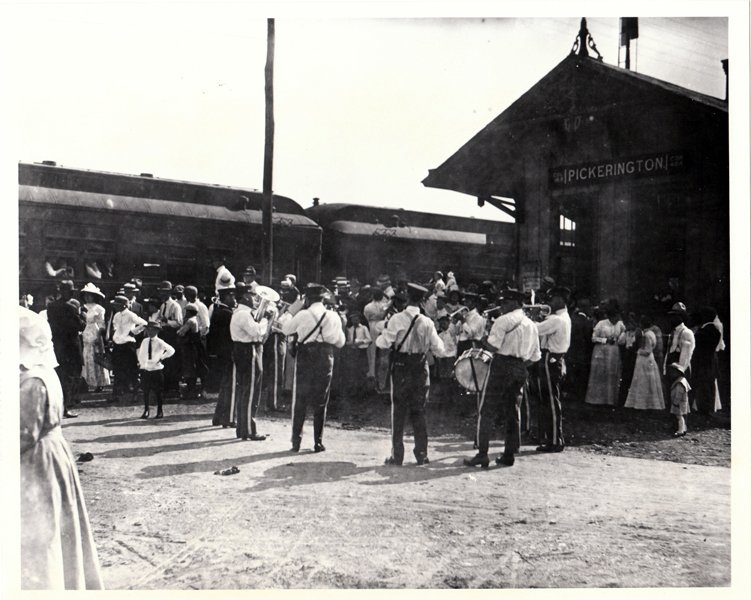 A vintage photo of a marching band preparing for a parade