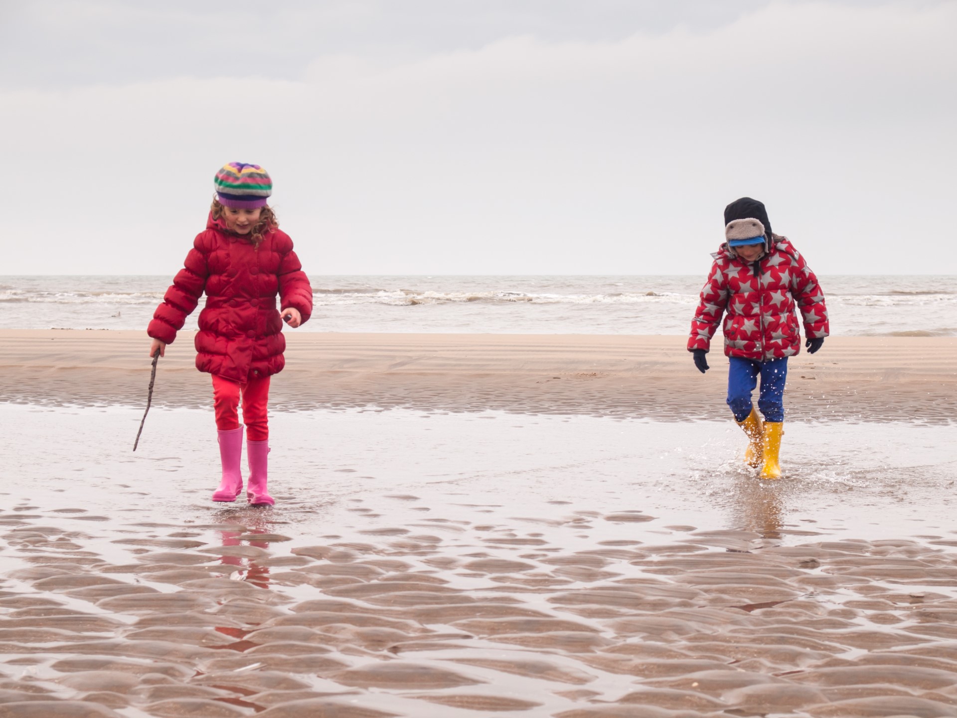 Children playing in the sea for Febraury half term break