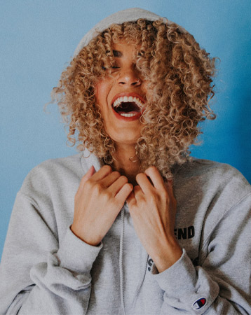 Woman with curly hair wearing a hoodie