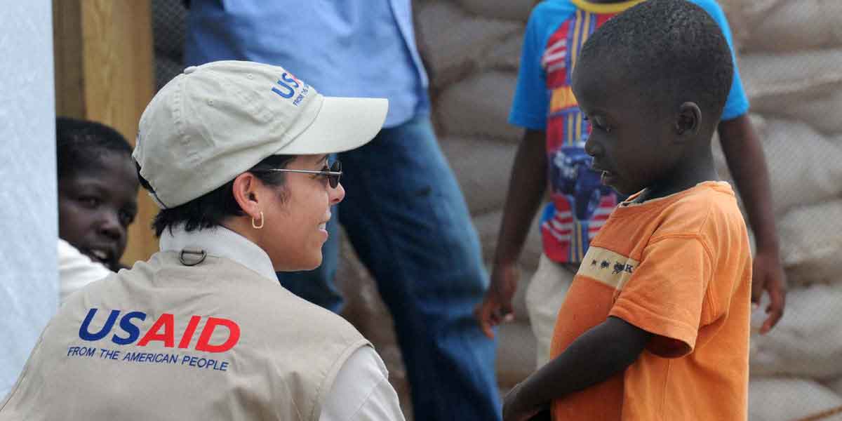 Alexandra Riboul with USAID talks with children at Tabarre Issa Emergency Relocation Camp in Haiti on June 7, 2010.