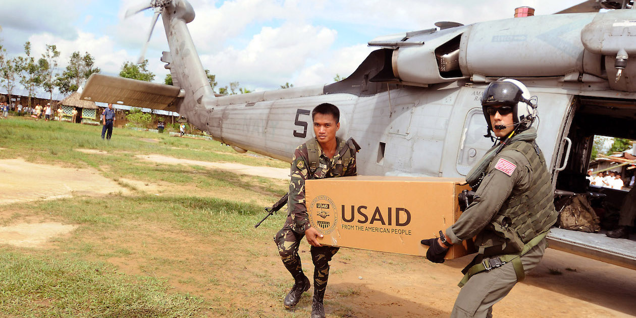 US and Philippines soldiers unload relief supplies to a school on Panay Island in the Philippines. Photo by DVIDSHUB, licensed under (CC BY 2.0).