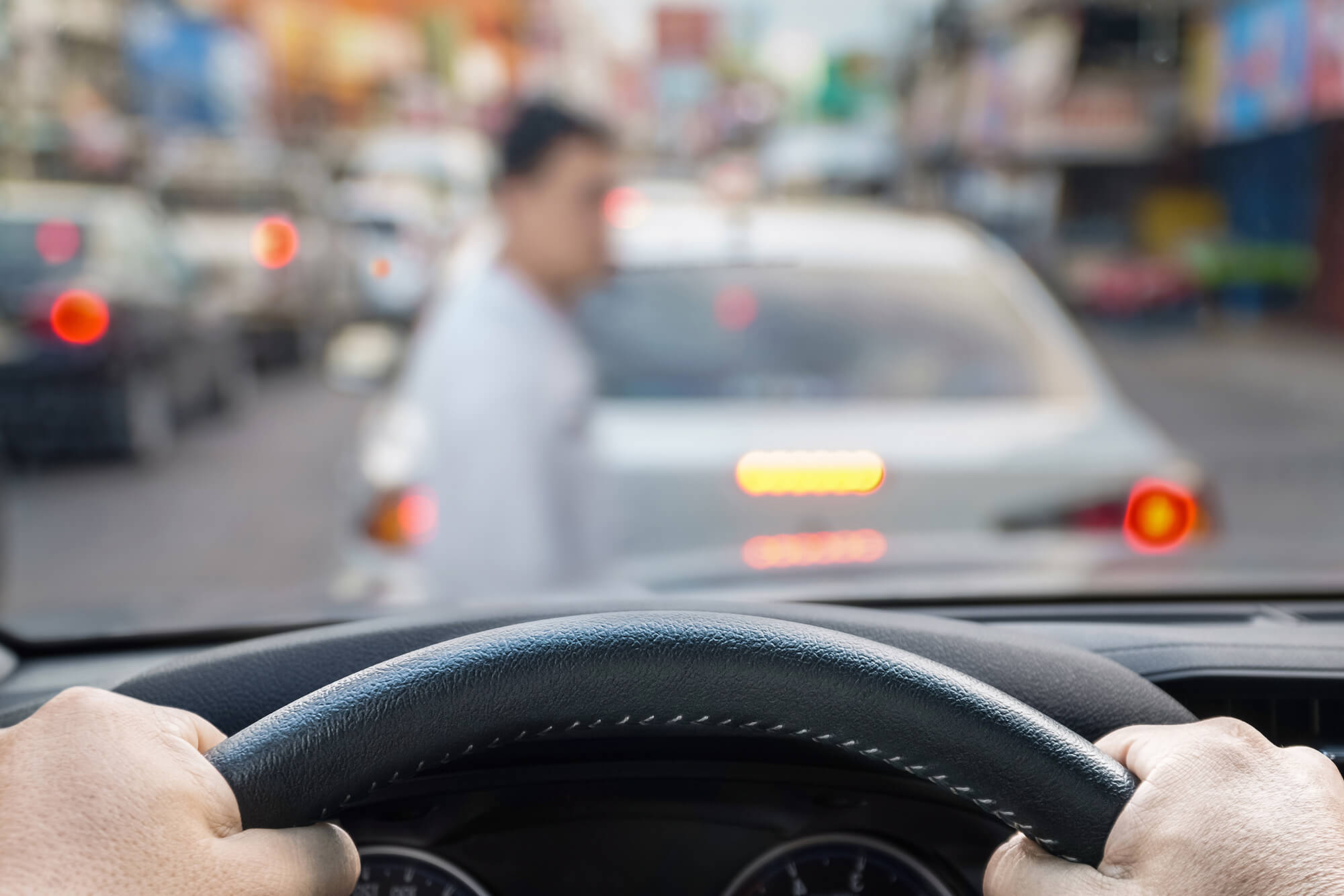 Photo of a pedestrian walking in front of a moving vehicle