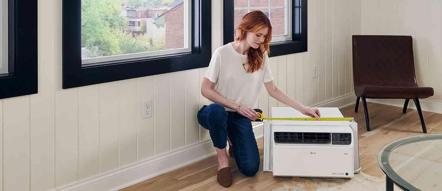 A woman installing an LG Air Conditioner