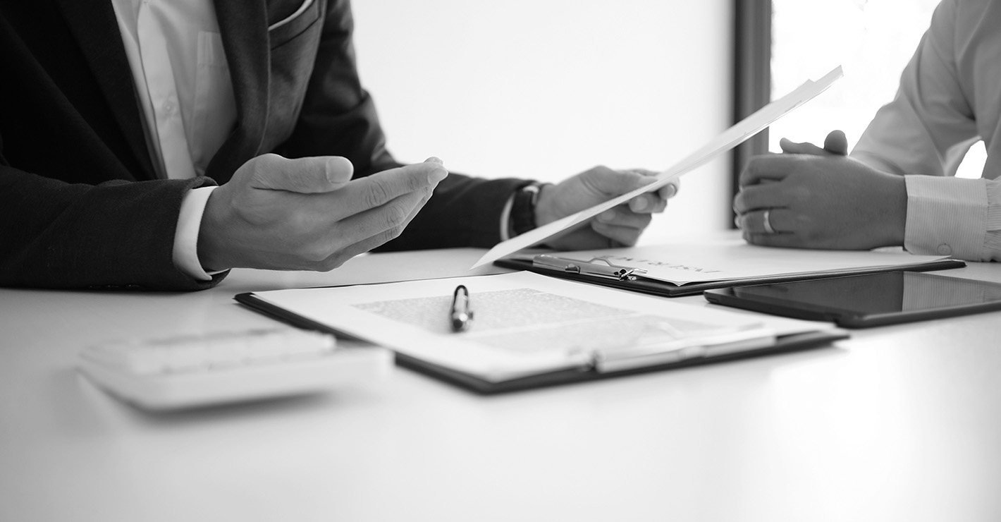 Two people talk to each other while reviewing the taxability of a personal injury settlement.