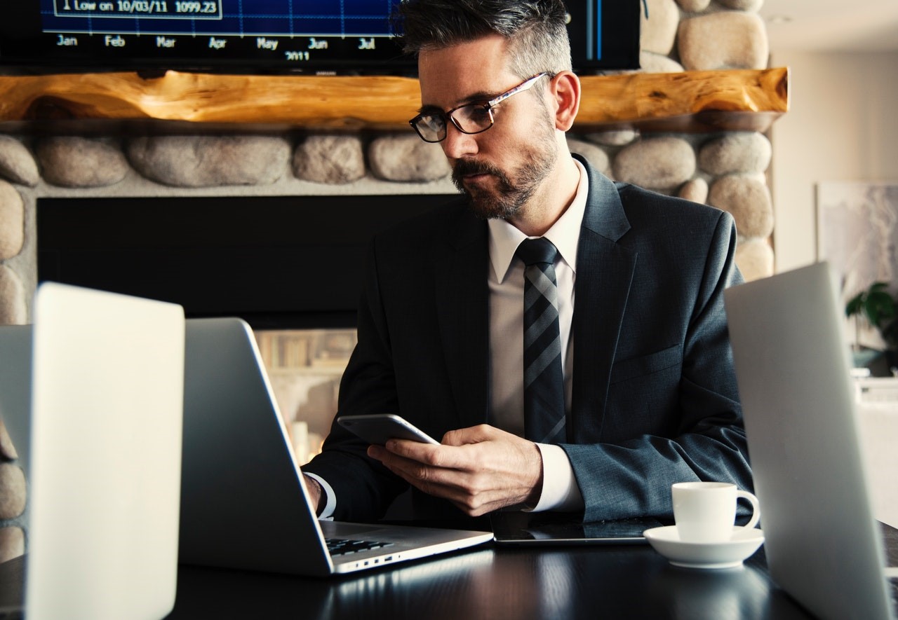 Sales person on phone in front of laptop