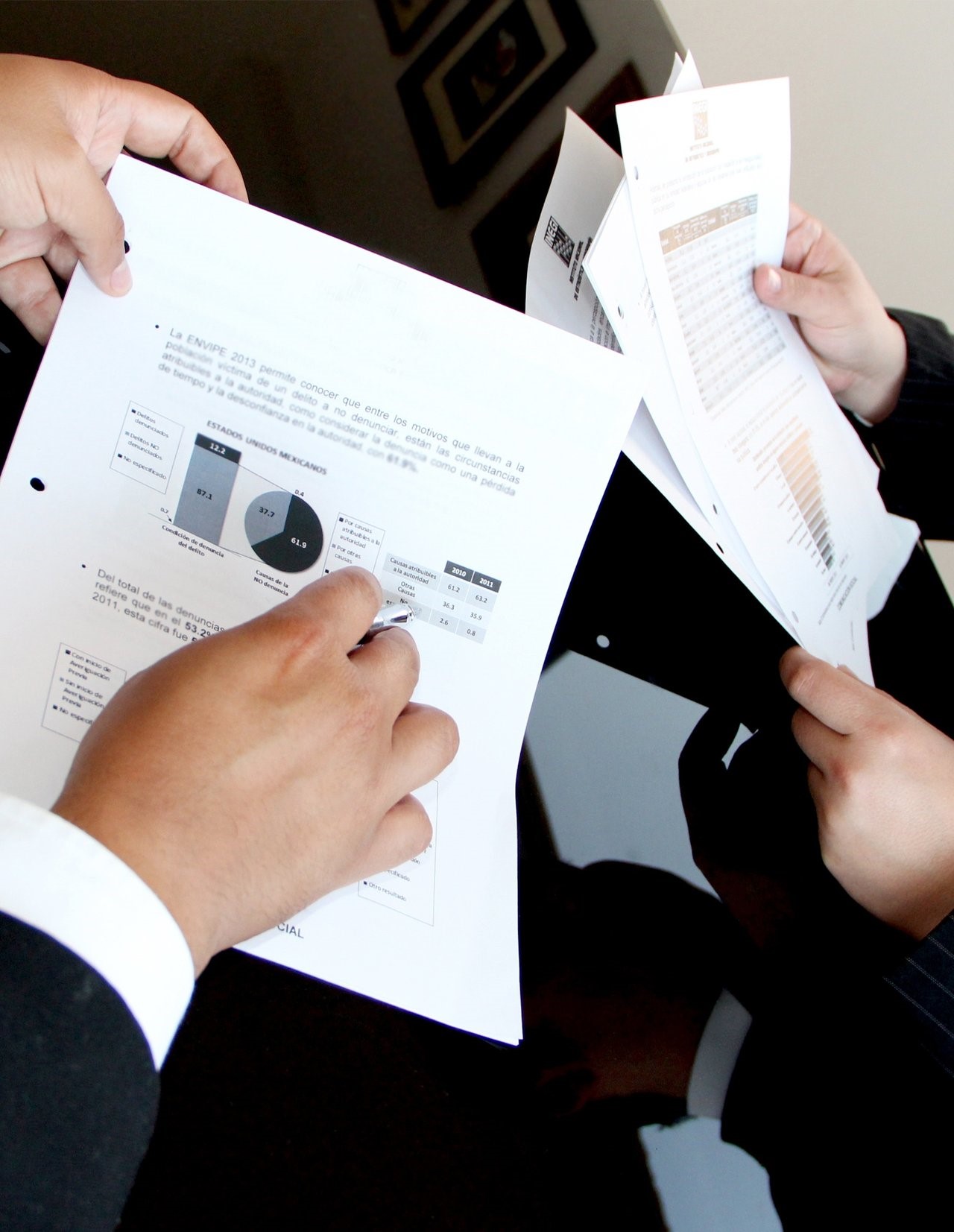 People holding documents with statistics and document control checklist