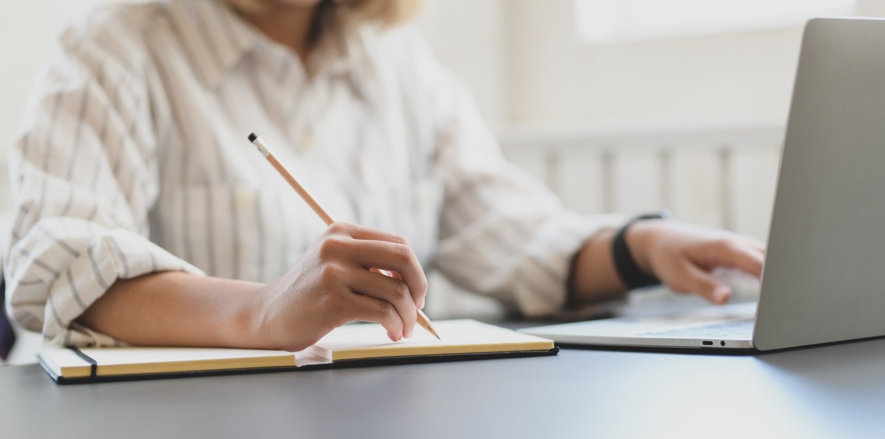 Person writing on a document