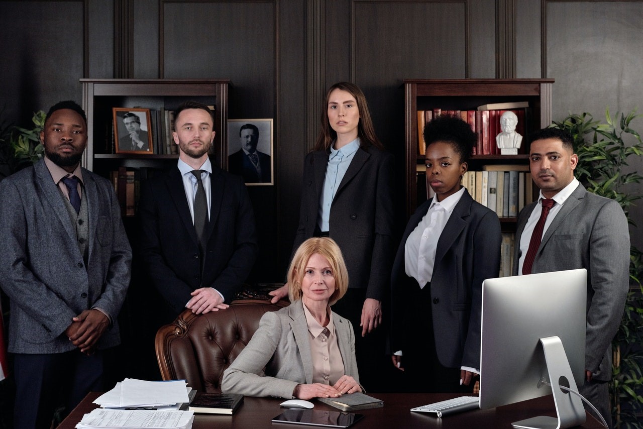 Legal team standing around a desk