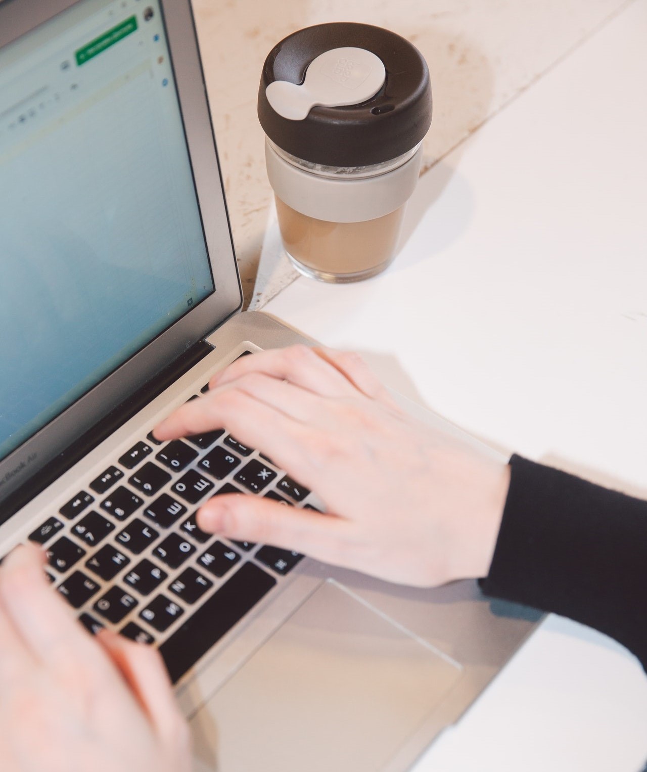 Person using a laptop showing a spreadsheet