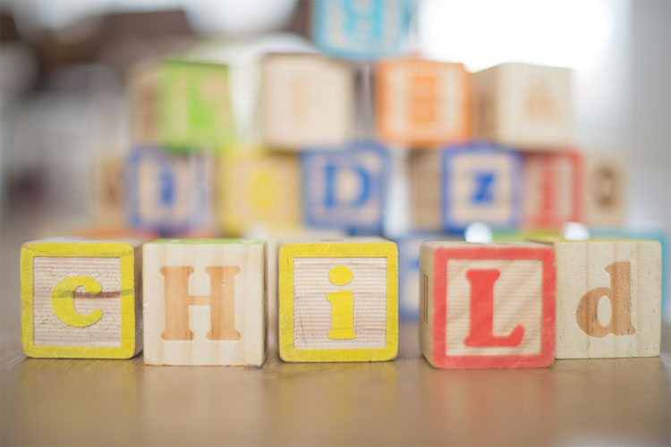 Chemical use is a major concern in a safe and healthy child care setting where blocks lie on the floor spelling child.