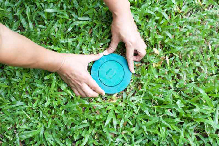 A termite baiting system being installed