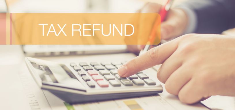 person using a calculator to work out tax refund