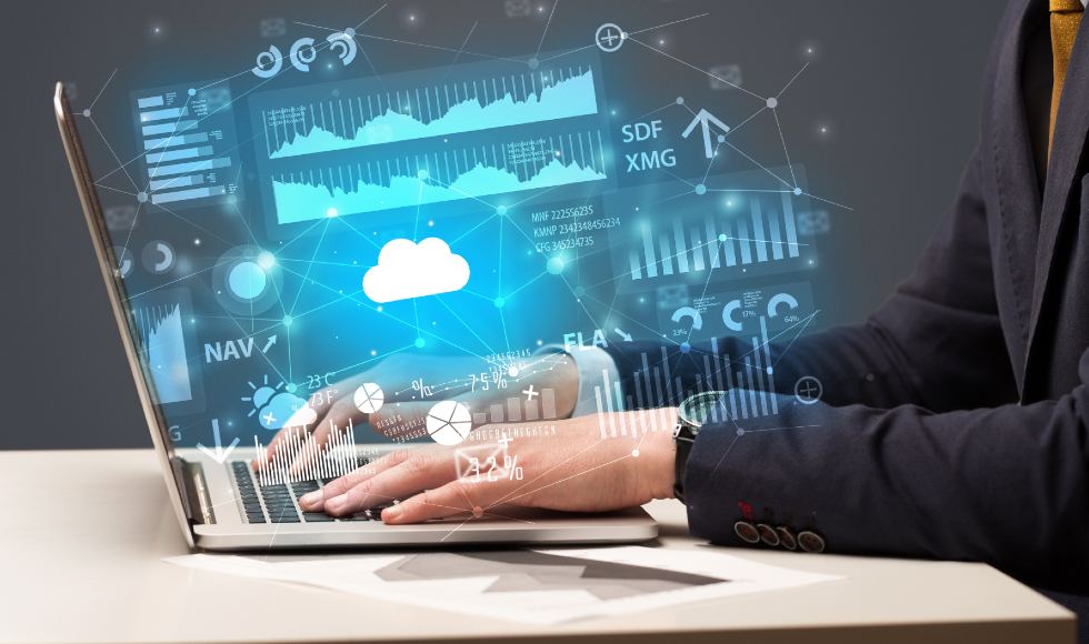 a businessman typing on a laptop with cloud reports and graph concepts around