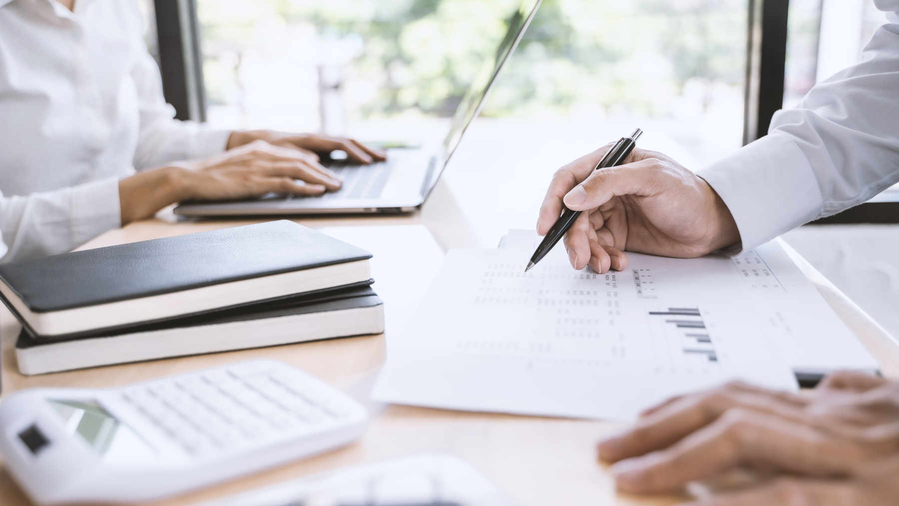 man calculating corporate tax